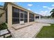 Spacious screened patio with brick pavers and a view of the backyard at 211 Shell Creek Ct, Apollo Beach, FL 33572