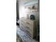 Bedroom with dresser and beach-themed wall art at 22481 Westchester Blvd # A23, Punta Gorda, FL 33980