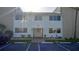 Two-story building exterior with light-colored siding and parking at 22481 Westchester Blvd # A23, Punta Gorda, FL 33980