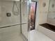Bathroom with shower, bathtub, and access to backyard at 2280 Toniwood Ln, Palm Harbor, FL 34685