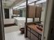 Retro bathroom with brown tile, bathtub, and vanity at 2280 Toniwood Ln, Palm Harbor, FL 34685