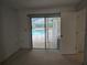 Bedroom with sliding glass doors leading to the pool at 2280 Toniwood Ln, Palm Harbor, FL 34685