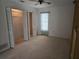 Bedroom with mirrored closet doors and window at 2280 Toniwood Ln, Palm Harbor, FL 34685