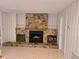 Stone fireplace with built-in shelving in a cozy living room at 2280 Toniwood Ln, Palm Harbor, FL 34685