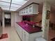 Kitchen with white cabinets, dark countertops, and a breakfast bar at 2280 Toniwood Ln, Palm Harbor, FL 34685