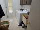 Laundry room with washer, dryer, and storage cabinets at 2280 Toniwood Ln, Palm Harbor, FL 34685