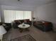 Living room with two sofas, a coffee table, and ample natural light at 2280 Toniwood Ln, Palm Harbor, FL 34685