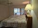 Main bedroom with a king-size bed and a view of the pool at 2280 Toniwood Ln, Palm Harbor, FL 34685