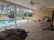 Spacious pool patio with covered lanai and seating at 2280 Toniwood Ln, Palm Harbor, FL 34685