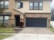 Two-story house with stone accents and a two-car garage at 2588 Bartolo Dr, Land O Lakes, FL 34639