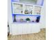 White bar cabinet with glass doors and blue LED lighting at 2602 W Nassau St, Tampa, FL 33607