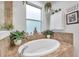 Relaxing bathroom with soaking tub and plants at 2602 W Nassau St, Tampa, FL 33607