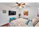 Bedroom with wood floors, mounted TV and decor at 2602 W Nassau St, Tampa, FL 33607