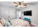 Bedroom with wood floors, mounted TV and decor at 2602 W Nassau St, Tampa, FL 33607