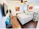 Bedroom with wood floors, mounted TV and decor at 2602 W Nassau St, Tampa, FL 33607