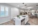 Modern kitchen with white cabinets, stainless steel appliances, and island at 2602 W Nassau St, Tampa, FL 33607