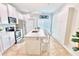Modern kitchen with white cabinets, stainless steel appliances, and island at 2602 W Nassau St, Tampa, FL 33607