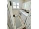 Bright laundry room with washer, dryer, and cabinets at 2602 W Nassau St, Tampa, FL 33607