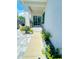 Stone pathway leading to the back door, lined with flowers at 2602 W Nassau St, Tampa, FL 33607