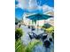 Relaxing patio with seating area, umbrella, and lush landscaping at 2602 W Nassau St, Tampa, FL 33607