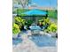 Small patio with table and chairs, surrounded by greenery at 2602 W Nassau St, Tampa, FL 33607