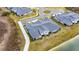 Aerial view of home near lake with gray tile roof at 31428 Briars Ml, San Antonio, FL 33576