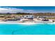 Aerial view of resort-style amenities including a lagoon pool, sandy beach, and clubhouse at 31428 Briars Ml, San Antonio, FL 33576