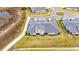 Aerial view of home near lake with gray tile roof at 31428 Briars Ml, San Antonio, FL 33576