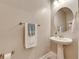 Simple bathroom, featuring a pedestal sink and a round mirror at 31428 Briars Ml, San Antonio, FL 33576