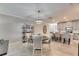Open concept dining room with kitchen access and modern lighting at 31428 Briars Ml, San Antonio, FL 33576
