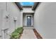 Front entry with gray door and brick walkway at 31428 Briars Ml, San Antonio, FL 33576