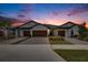 Three-car garage townhomes at sunset at 31428 Briars Ml, San Antonio, FL 33576
