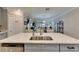 Kitchen island with sink and views into living area at 31428 Briars Ml, San Antonio, FL 33576