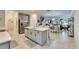 Modern kitchen with island, stainless steel appliances, and white cabinets at 31428 Briars Ml, San Antonio, FL 33576