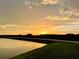 Sunset over tranquil lake and community at 31428 Briars Ml, San Antonio, FL 33576