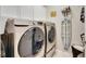 Laundry room with washer, dryer, and ironing board at 31428 Briars Ml, San Antonio, FL 33576