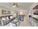 Spacious living room with gray sectional sofa and large TV at 31428 Briars Ml, San Antonio, FL 33576