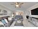 Spacious living room with gray sectional sofa and large TV at 31428 Briars Ml, San Antonio, FL 33576