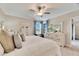 Bright main bedroom with water views and ceiling fan at 31428 Briars Ml, San Antonio, FL 33576