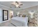 Spacious main bedroom with ceiling fan and large bed at 31428 Briars Ml, San Antonio, FL 33576
