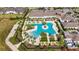 Aerial view of community pool and clubhouse with surrounding landscaping at 31428 Briars Ml, San Antonio, FL 33576