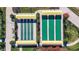Aerial view of two shuffleboard courts with covered seating areas at 31428 Briars Ml, San Antonio, FL 33576