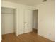 Bedroom with light wood floors, a closet and an additional door at 3201 Delaware W Ave, Plant City, FL 33563