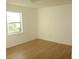 Bedroom with a window, light wood floors and neutral walls at 3201 Delaware W Ave, Plant City, FL 33563