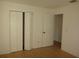 Bedroom with light wood floors, double door closet and an additional door at 3201 Delaware W Ave, Plant City, FL 33563