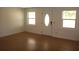Living room featuring light wood floors, neutral walls, and a white door at 3201 Delaware W Ave, Plant City, FL 33563