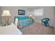 Bedroom with daybed and teal bedding at 3521 Teeside Dr # 3521, New Port Richey, FL 34655