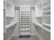 Large walk-in closet with custom shelving and hanging rods at 3521 Teeside Dr # 3521, New Port Richey, FL 34655