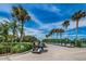 Golf cart parking area with lush landscaping at 3521 Teeside Dr # 3521, New Port Richey, FL 34655