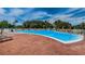 Resort-style swimming pool with brick patio and lounge chairs at 3521 Teeside Dr # 3521, New Port Richey, FL 34655
